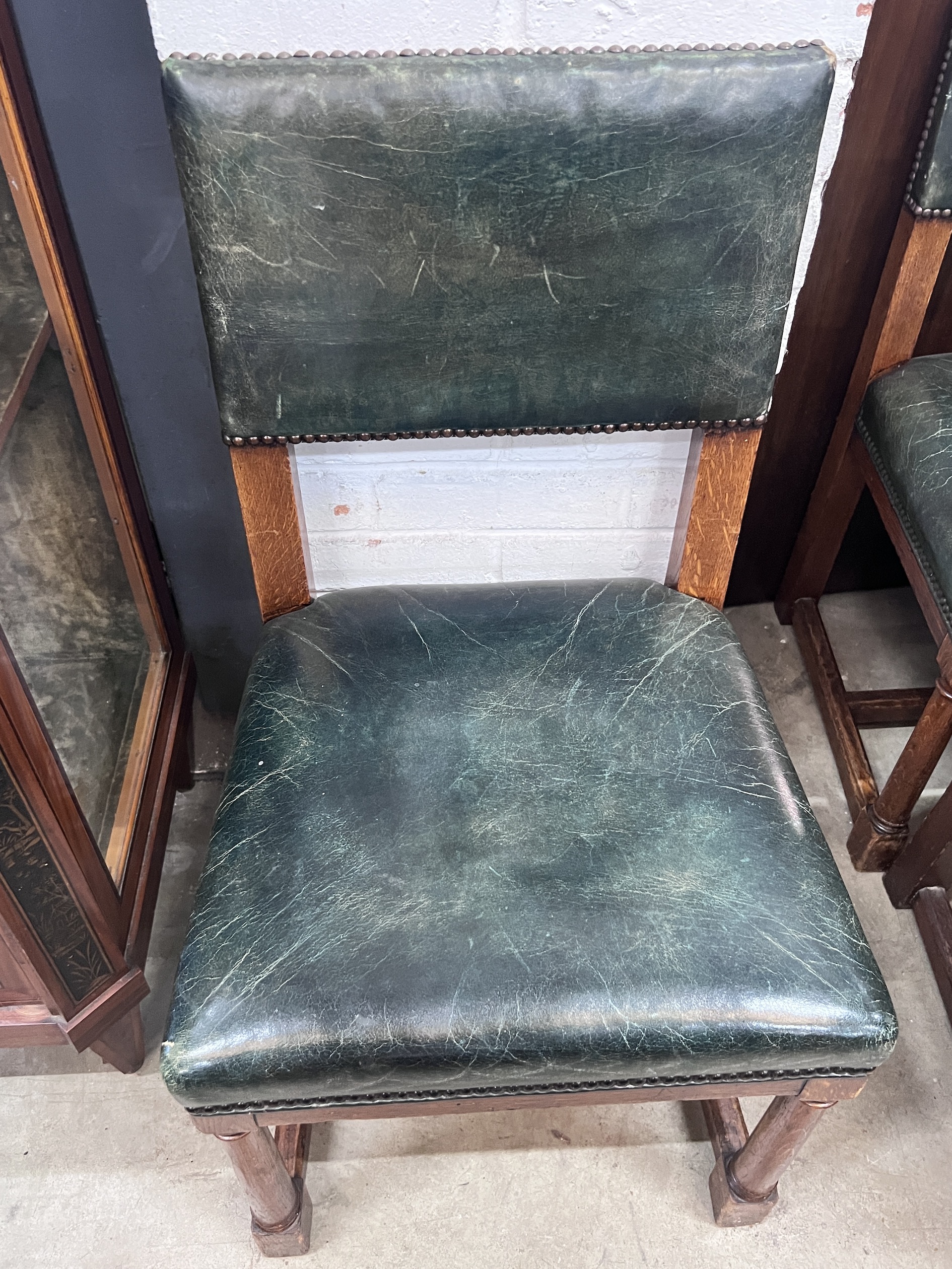 A set of five George VI oak and green leather 'House of Parliament' chairs by R & H Mines, Downley, width 46cm, depth 43cm, height 86cm